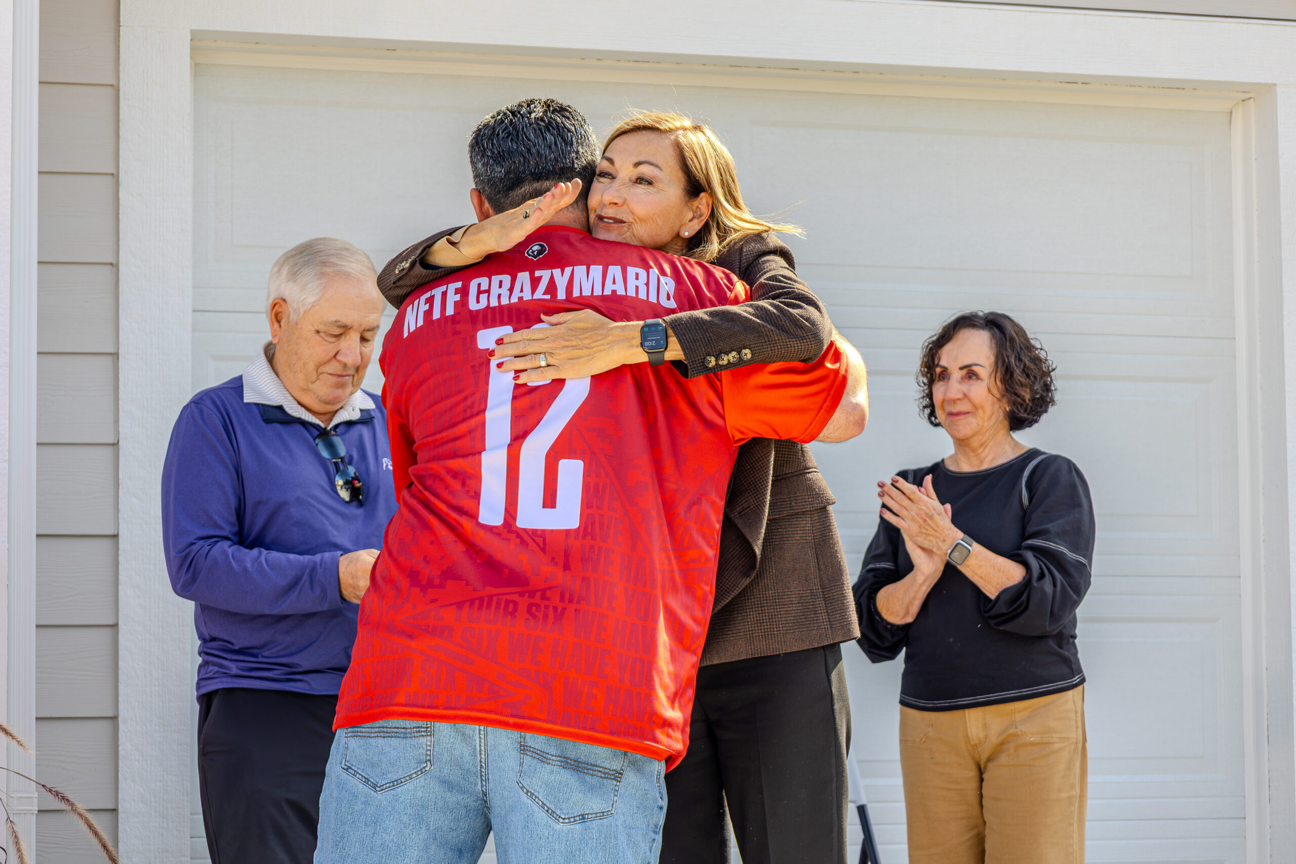 Donating Garage Door - Home for Heroes - Jimmy and Iowa's governor Kim Reynolds